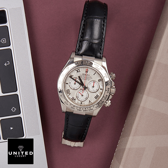 Rolex Daytona 116519 "White Roman Dial" First-Class Clone rolex daytona116519 replica leather Rolex Daytona 116519 Stainless Steel Case Black Leather Replica on the table