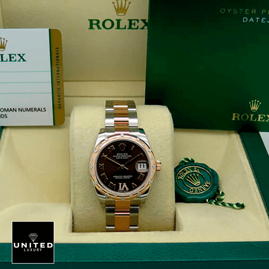 Rolex Datejust 178341 Superior Replica Rolex Datejust178341 Chocolate Roman Replica warranty card in the box next to it