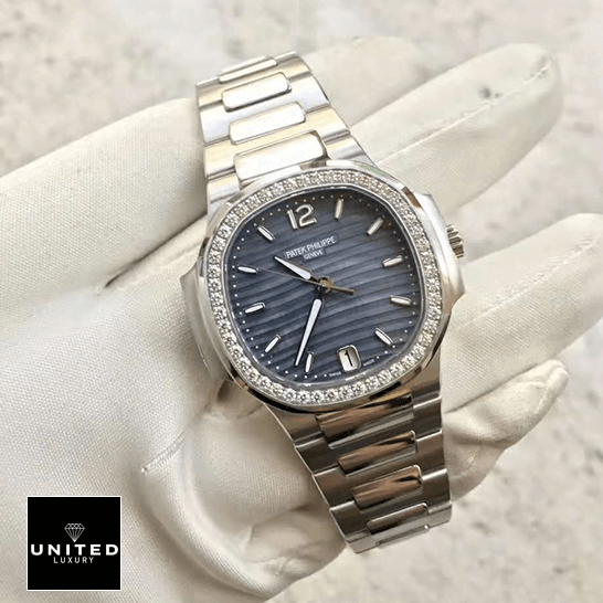 Patek Philippe Nautilus Ladies 7018/1A Elite Clone Edition patek philippe nautilus 70181A replica front Patek Philippe Diamond Bezel Blue Dial Steel Bracelet Replica on the white glove hand