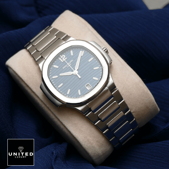 Patek Philippe Nautilus 7118/1A Ladies Perfect Duplicate 1:1 patekphilippe nautilus 71181A 001 replica STEEL Patek Philippe Nautilus 71181A-001 Steel Bezel Replica on the stand blue background