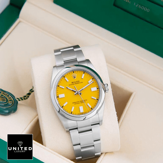 Rolex Oyster Perpetual 124300 "Orange Dial" Deluxe Clone 1:1 rolex oyster perpetual yellow dial 124300 replica box unitedluxurynet 1 Rolex Perpetual 124300 Oyster Yellow Dial Replica in the Green Box