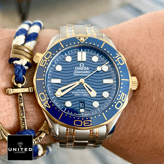 Omega Seamaster Diver 300m Gold Blue Dial Replica on the man wrist